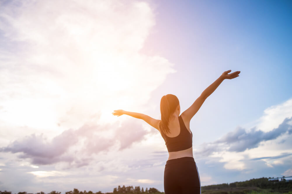 happy-smiling-athletic-woman-with-arms-outstretched